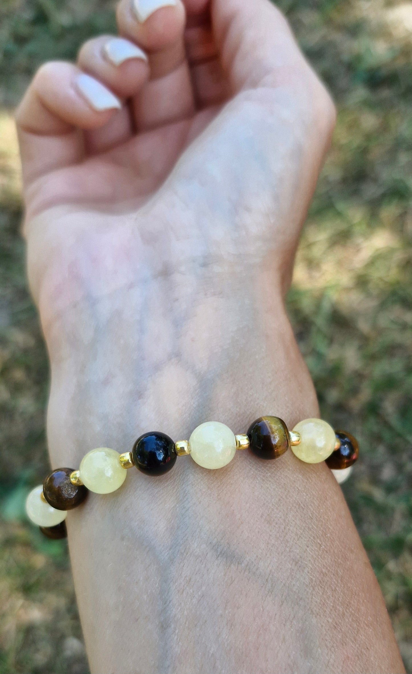Wrist wearing Citrine and Tiger Eye stretch bracelet with premium Toho glass bead details