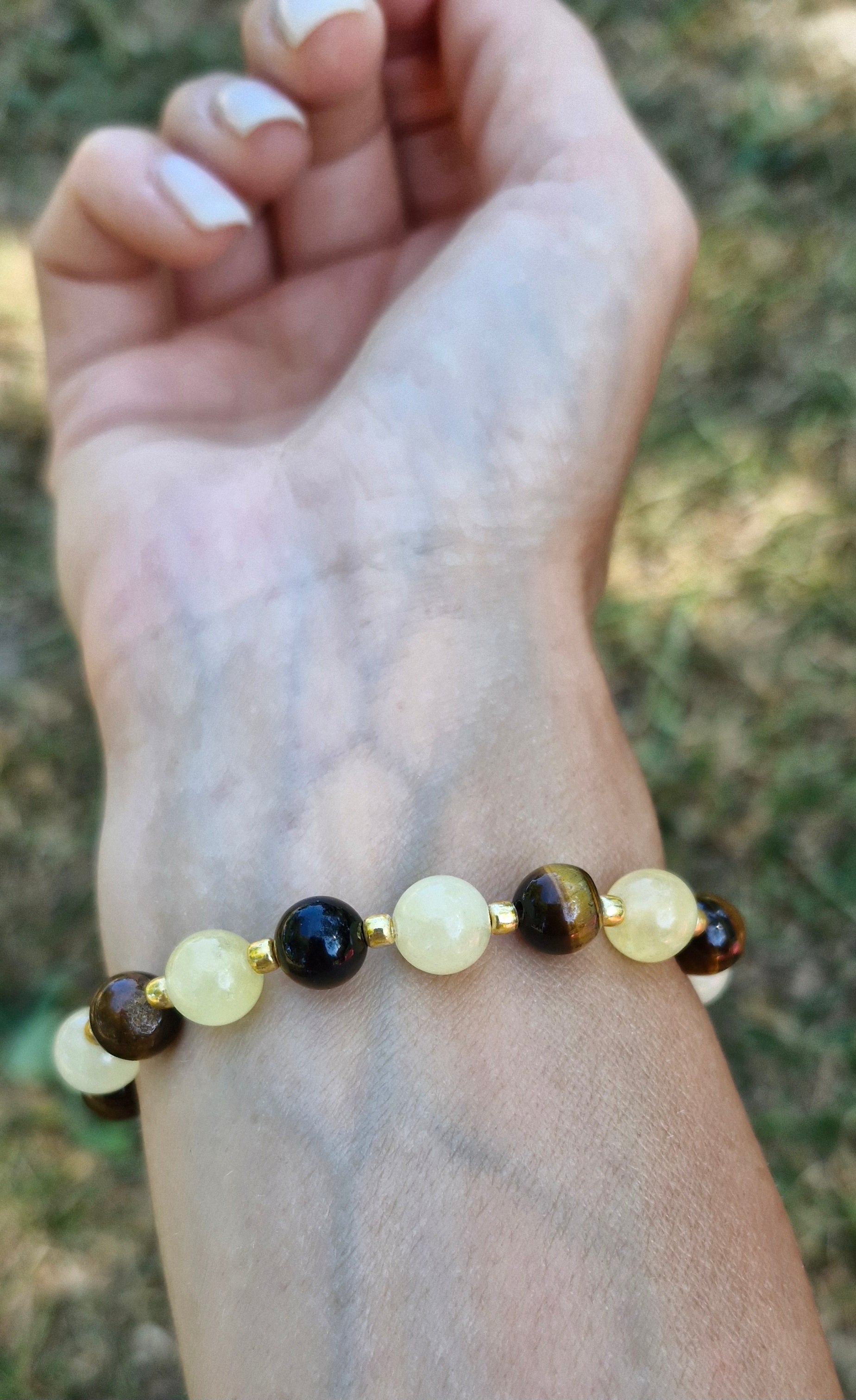 Wrist wearing Citrine and Tiger Eye stretch bracelet with premium Toho glass bead details