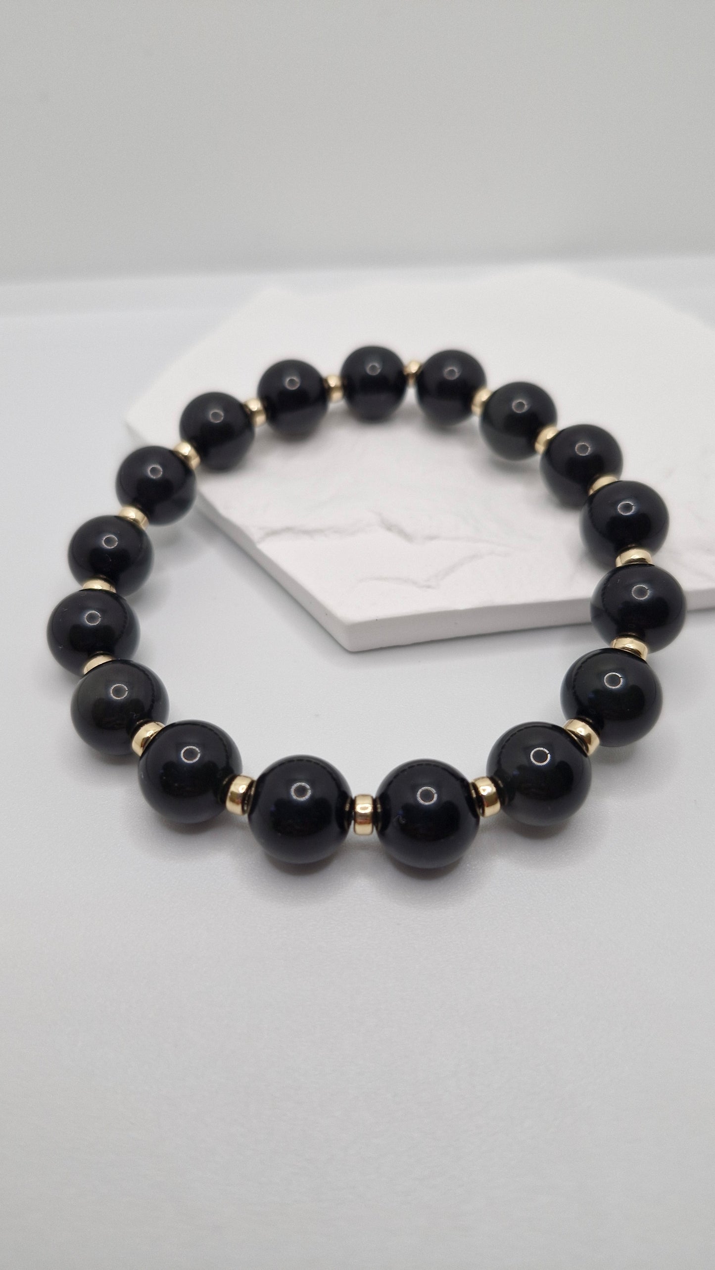 Handmade Black Obsidian stretch bracelet with smooth 4mm Gold Filled rondelle bead, perfect for daily wear and meditation.
