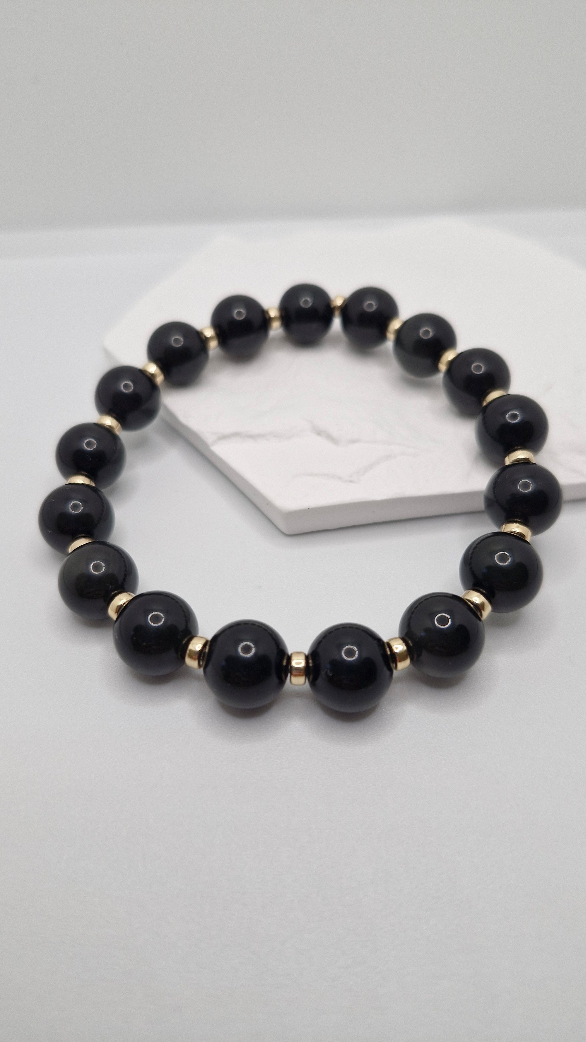 Handmade Black Obsidian stretch bracelet with smooth 4mm Gold Filled rondelle bead, perfect for daily wear and meditation.