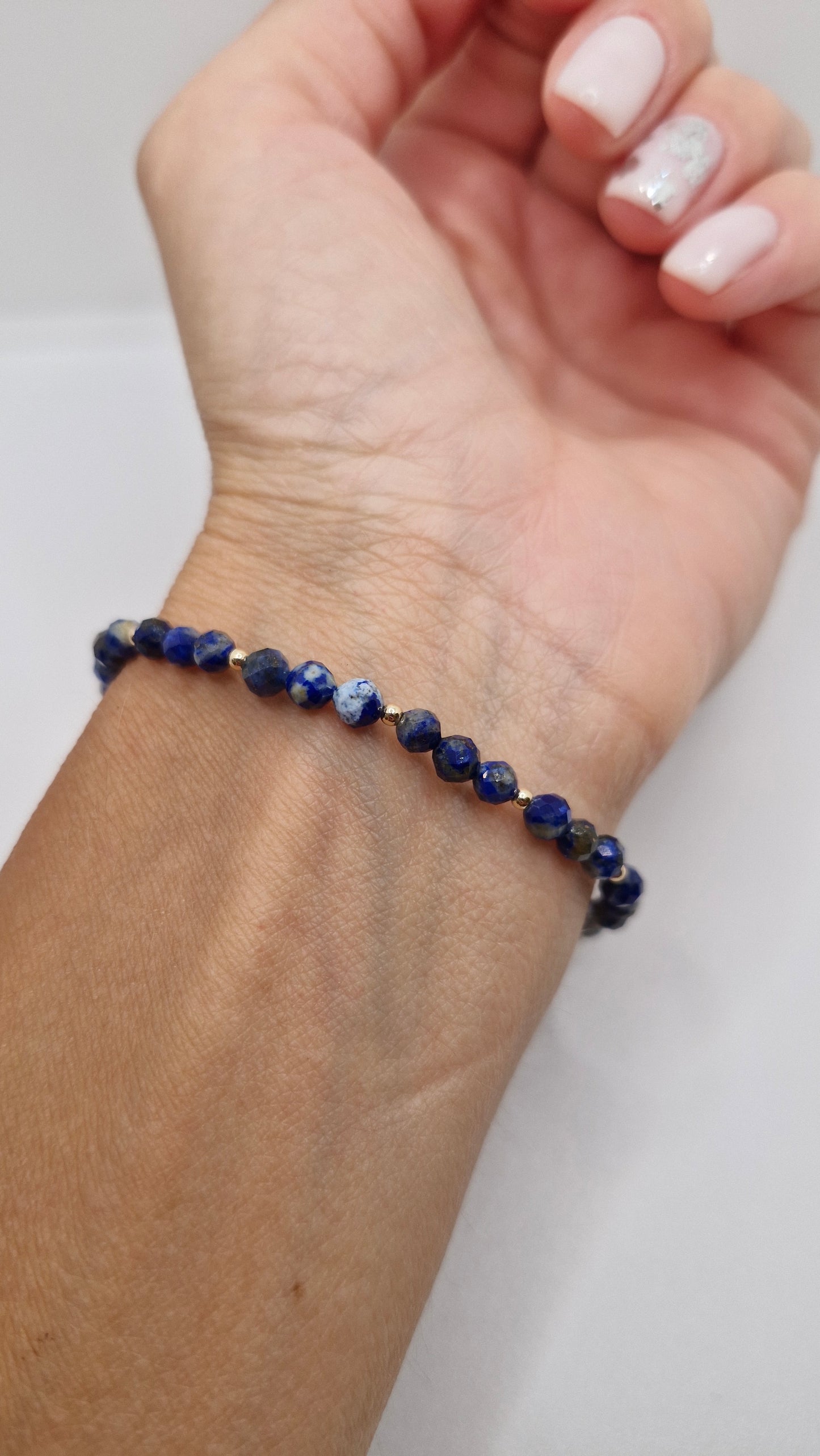 Elegant 4mm faceted Lapis Lazuli bracelet with 2mm gold filled accents and 6mm gold filled corrugated bead, styled on wrist