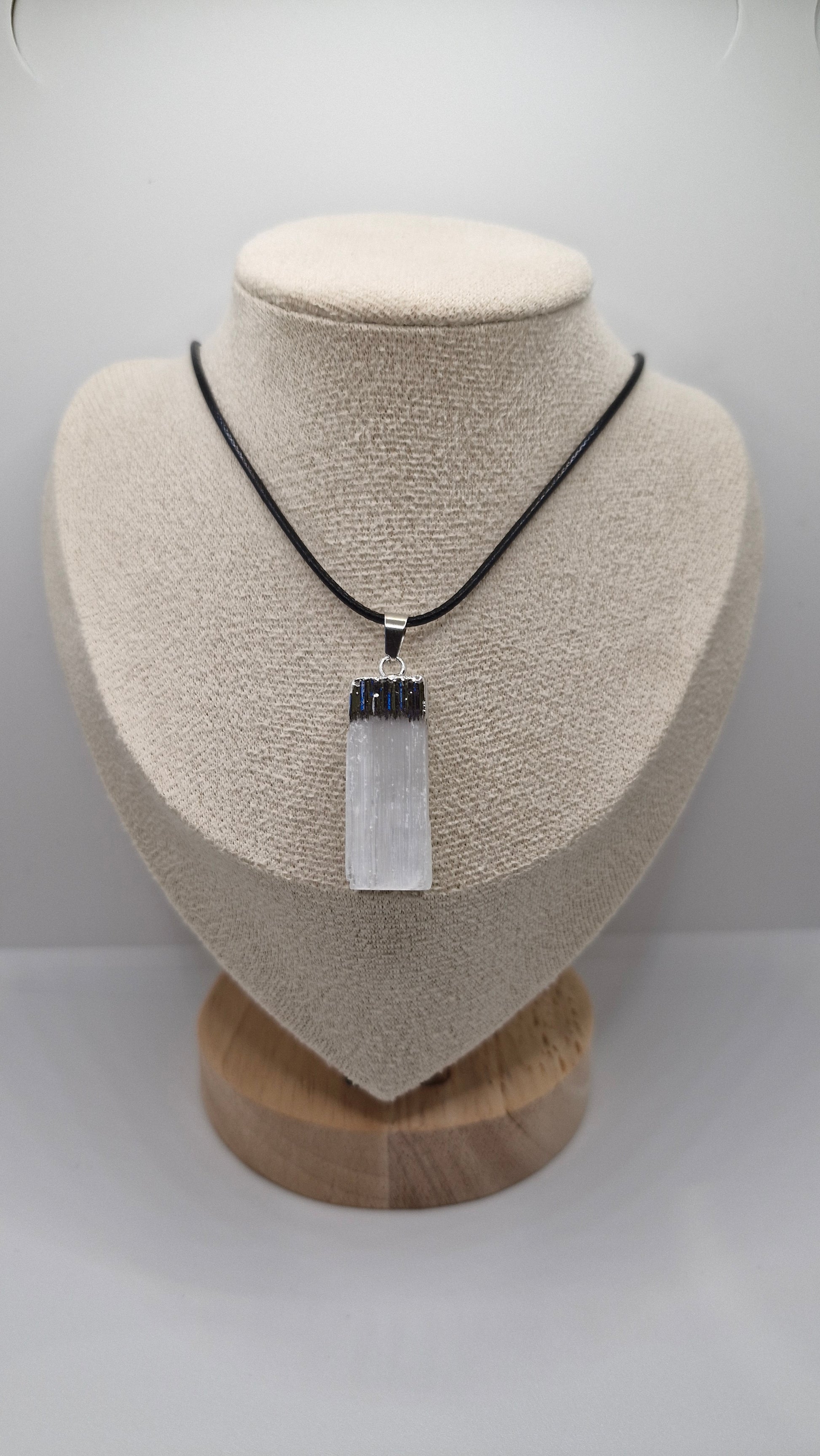 Rectangular Selenite gemstone pendant on adjustable black rope, promotes clarity, protection, and spiritual growth.