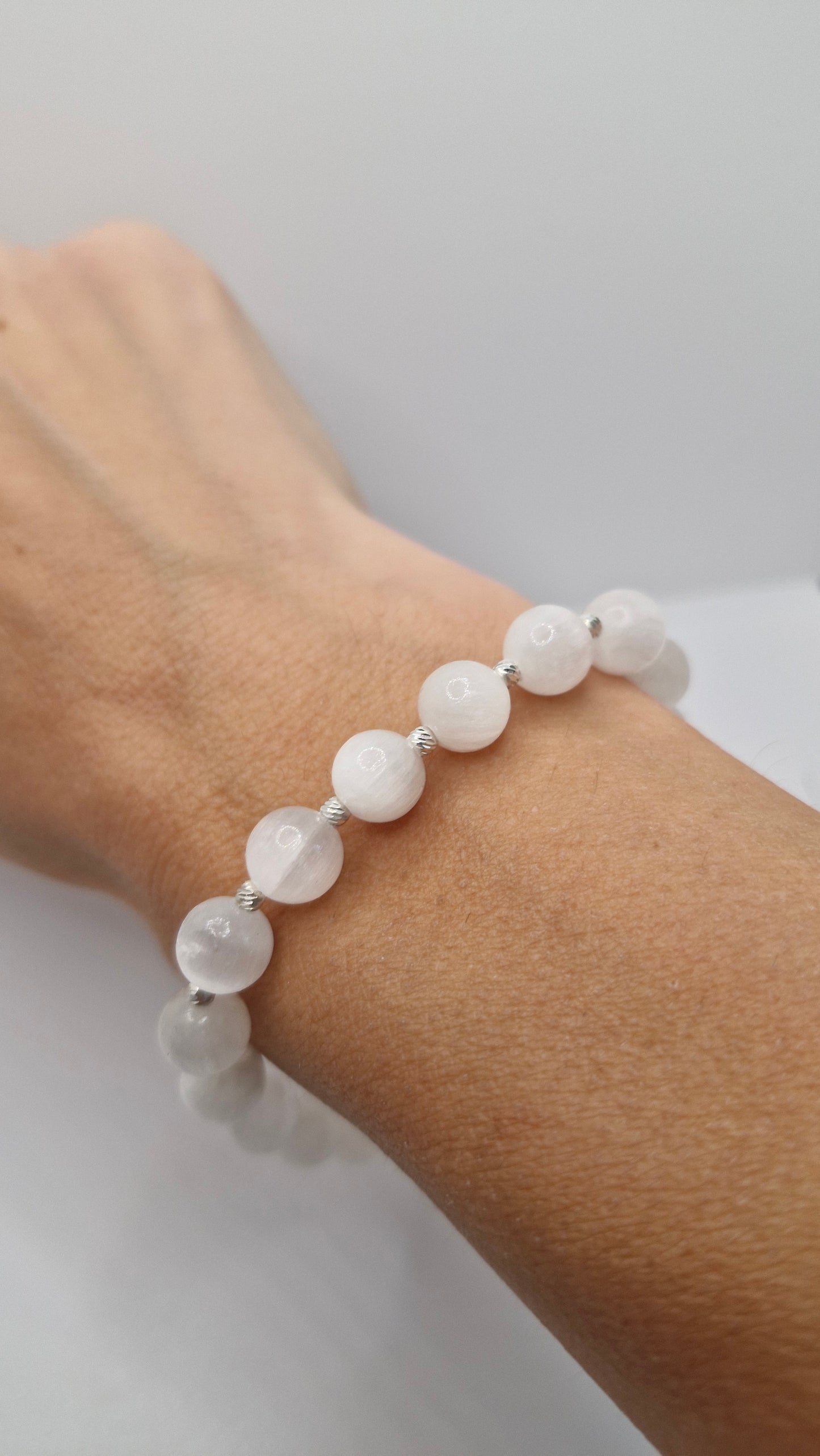 Handmade Selenite gemstone bracelet paired with casual outfit, accented with sterling silver beads