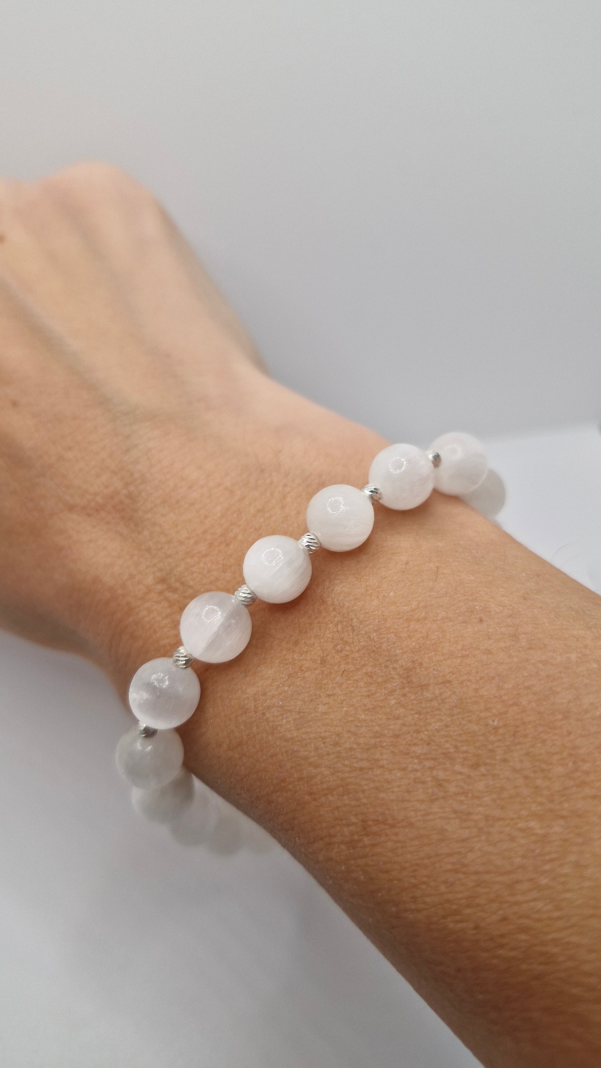 Handmade Selenite gemstone bracelet paired with casual outfit, accented with sterling silver beads