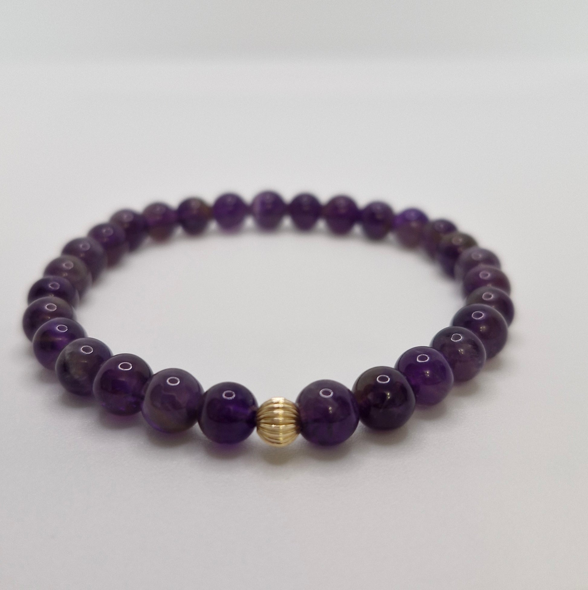 Close-up of 5mm gold filled corrugated accent bead on Amethyst bracelet