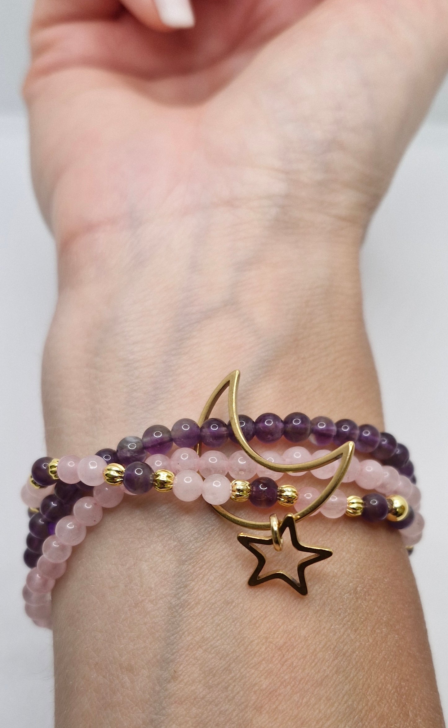 Stacked gemstone bracelet with pink and purple natural stones, gold-plated accents, and Moon & Star stainless steel charm