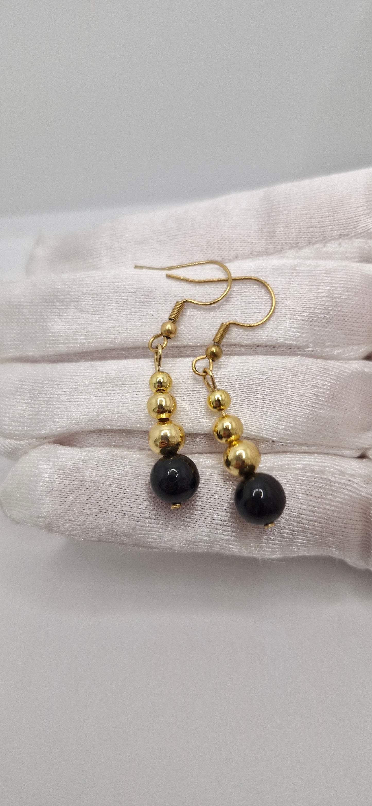 Protective natural Black Tourmaline gemstone earrings with golden details, handcrafted for everyday wear