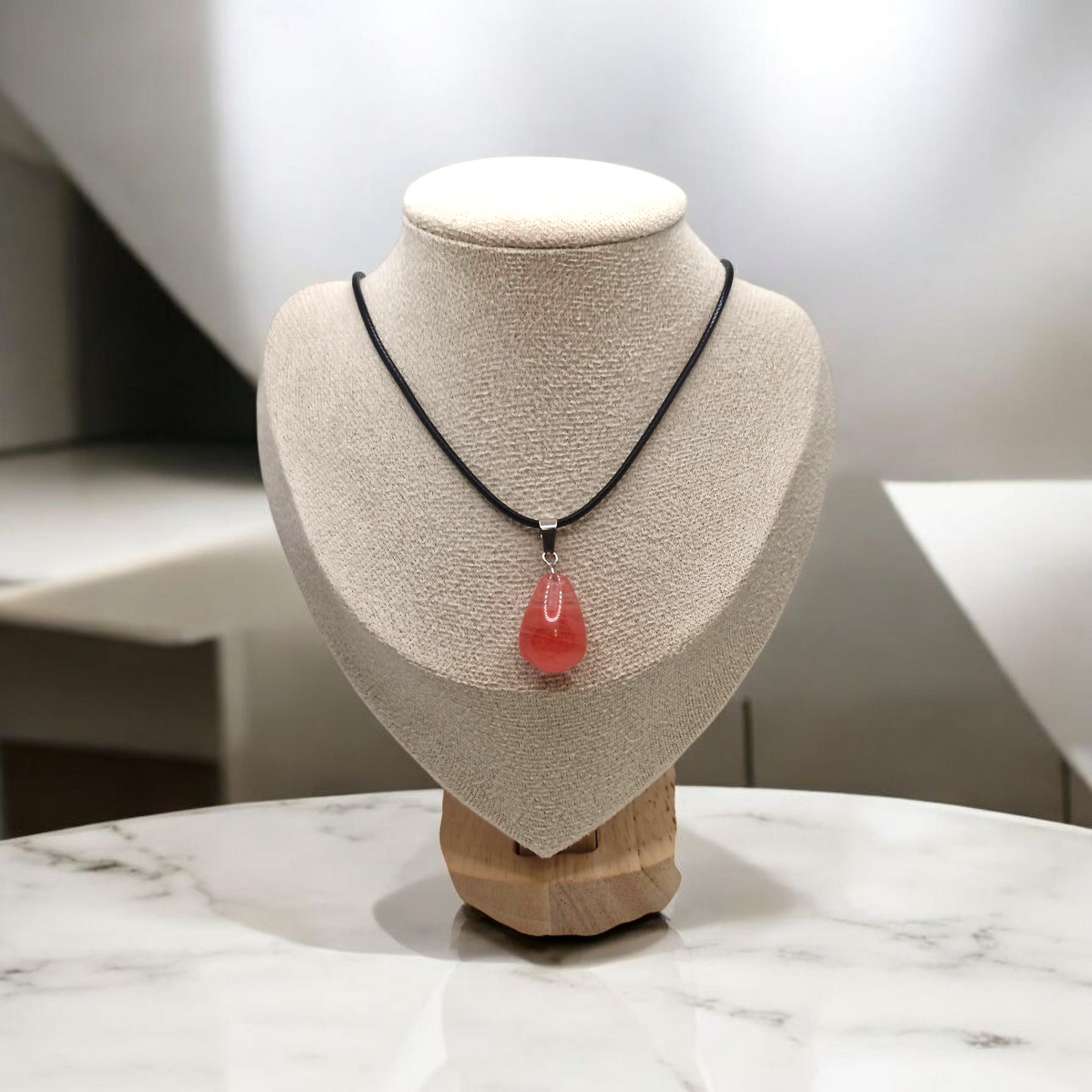 Cherry Quartz teardrop pendant necklace on adjustable black cord, pink gemstone symbolizing love and vitality.