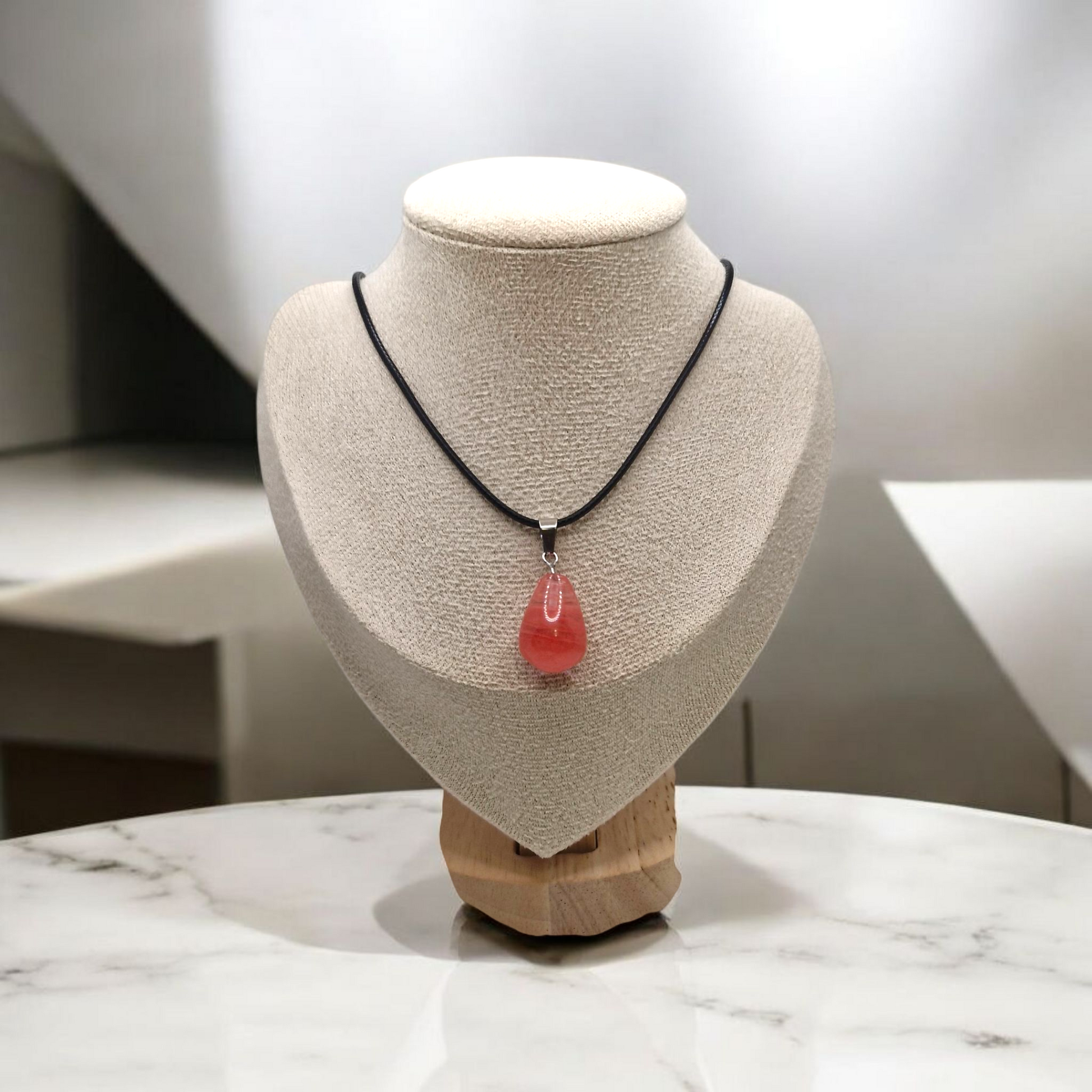 Cherry Quartz teardrop pendant necklace on adjustable black cord, pink gemstone symbolizing love and vitality.