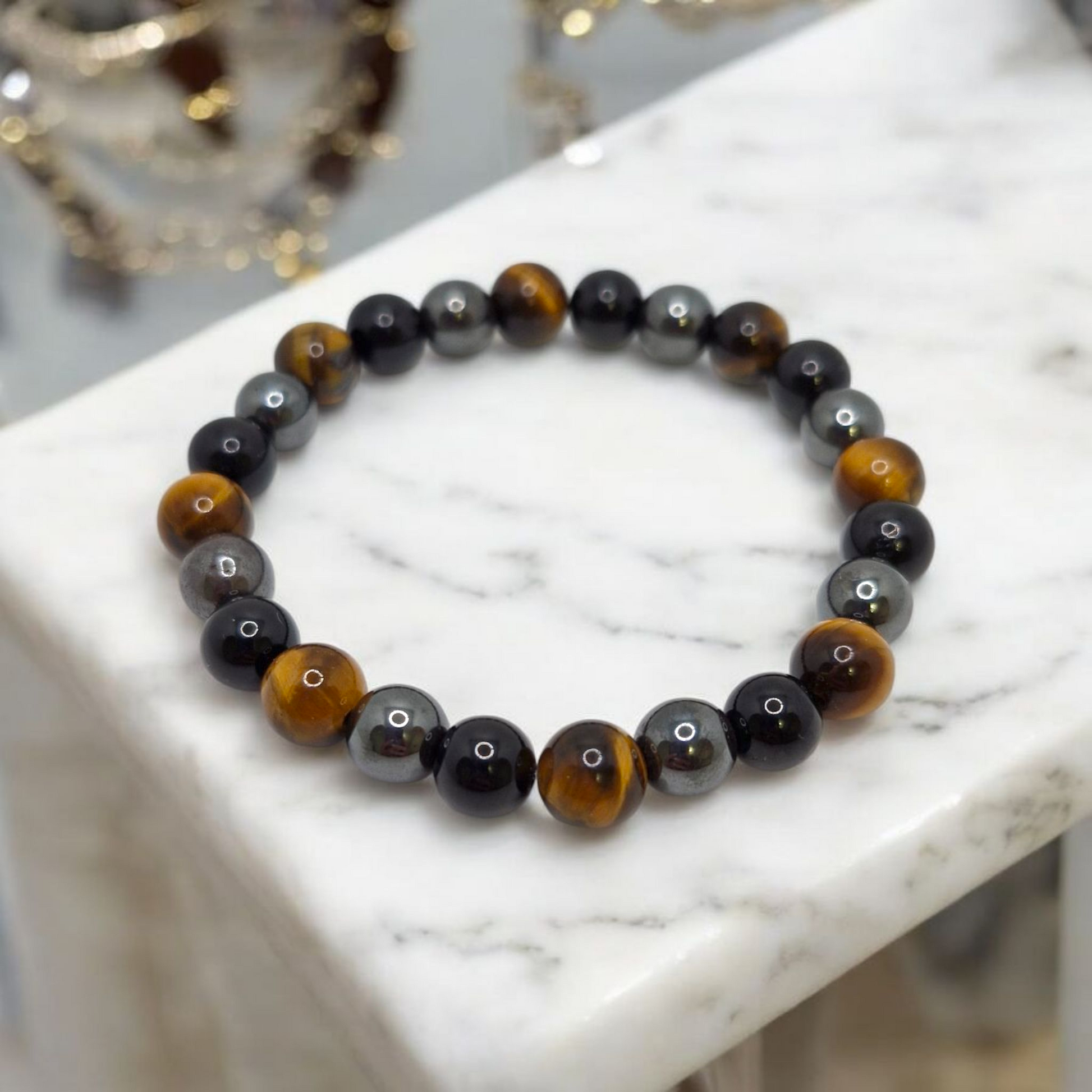 Close-up of natural Hematite, Tiger’s Eye, and Black Tourmaline beads — grounding and protective gemstone bracelet.