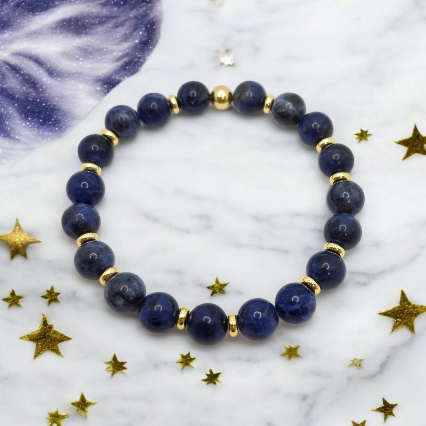 Dark blue Sodalite 8mm gemstone bracelet with gold-plated 5mm spacers and 6mm center bead, symbolizing intuition and calm.