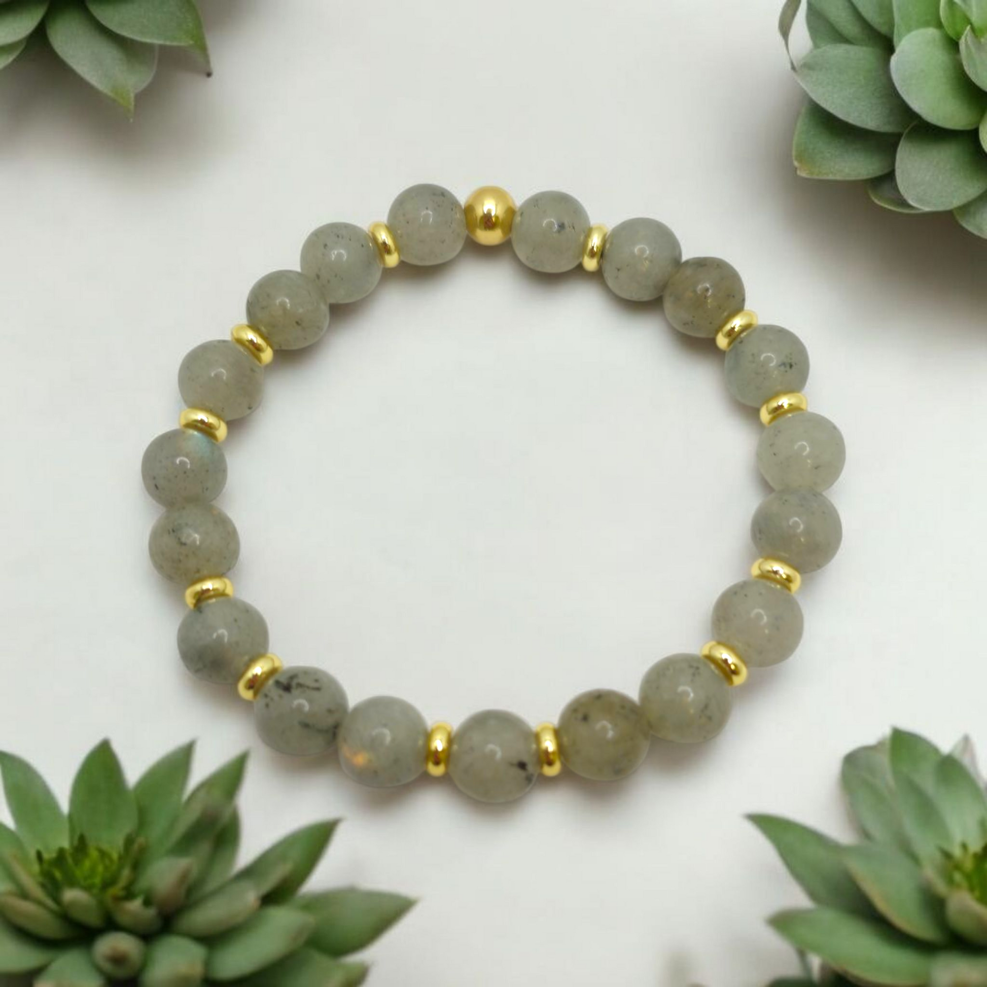 Natural Labradorite 8mm gemstone bracelet with gold-plated accents, showing iridescent flashes of blue and gray for protection and transformation.
