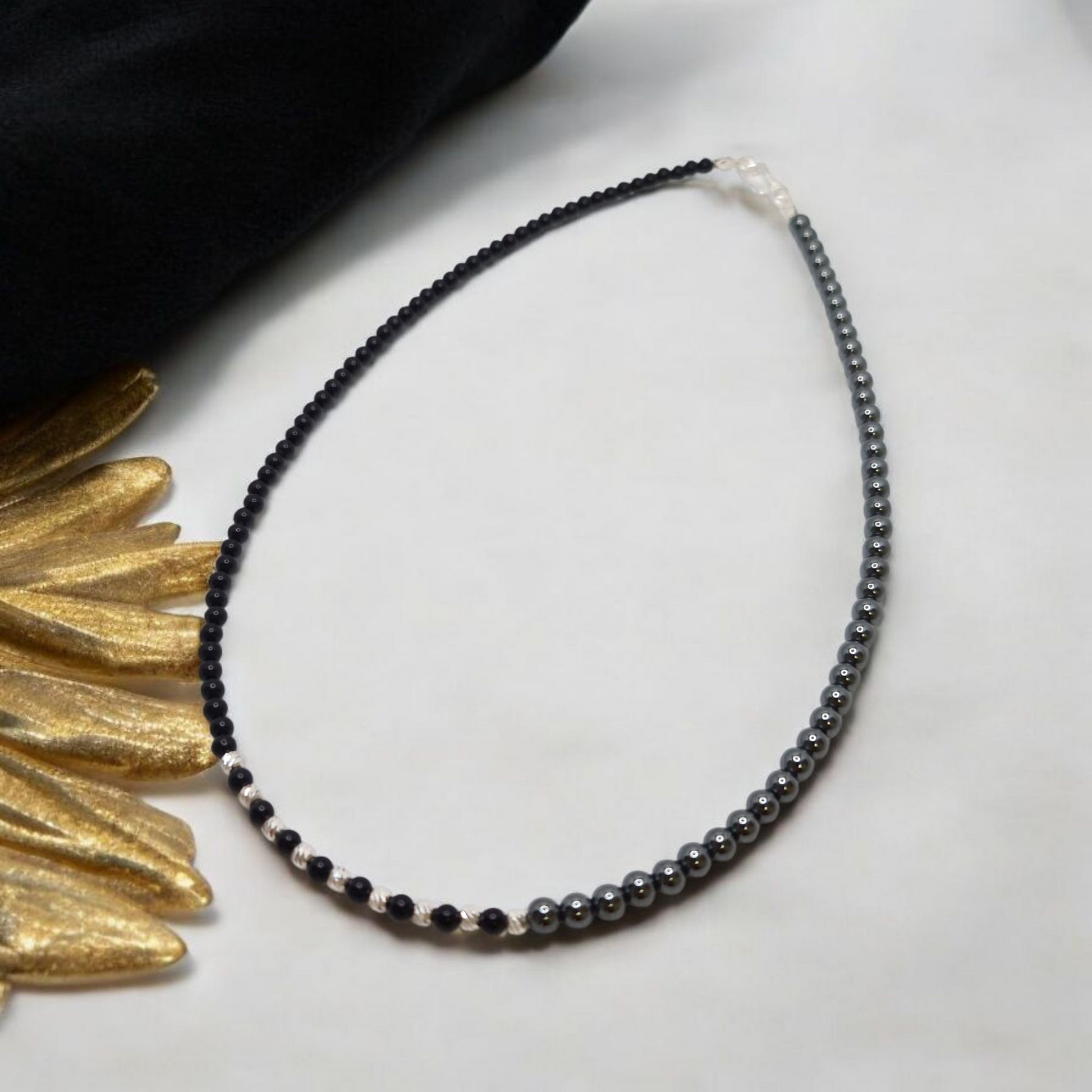 Handcrafted Onyx & Hematite necklace with sterling silver accents. Promotes strength, grounding & balance. Includes a free Selenite strip to recharge your gemstones.