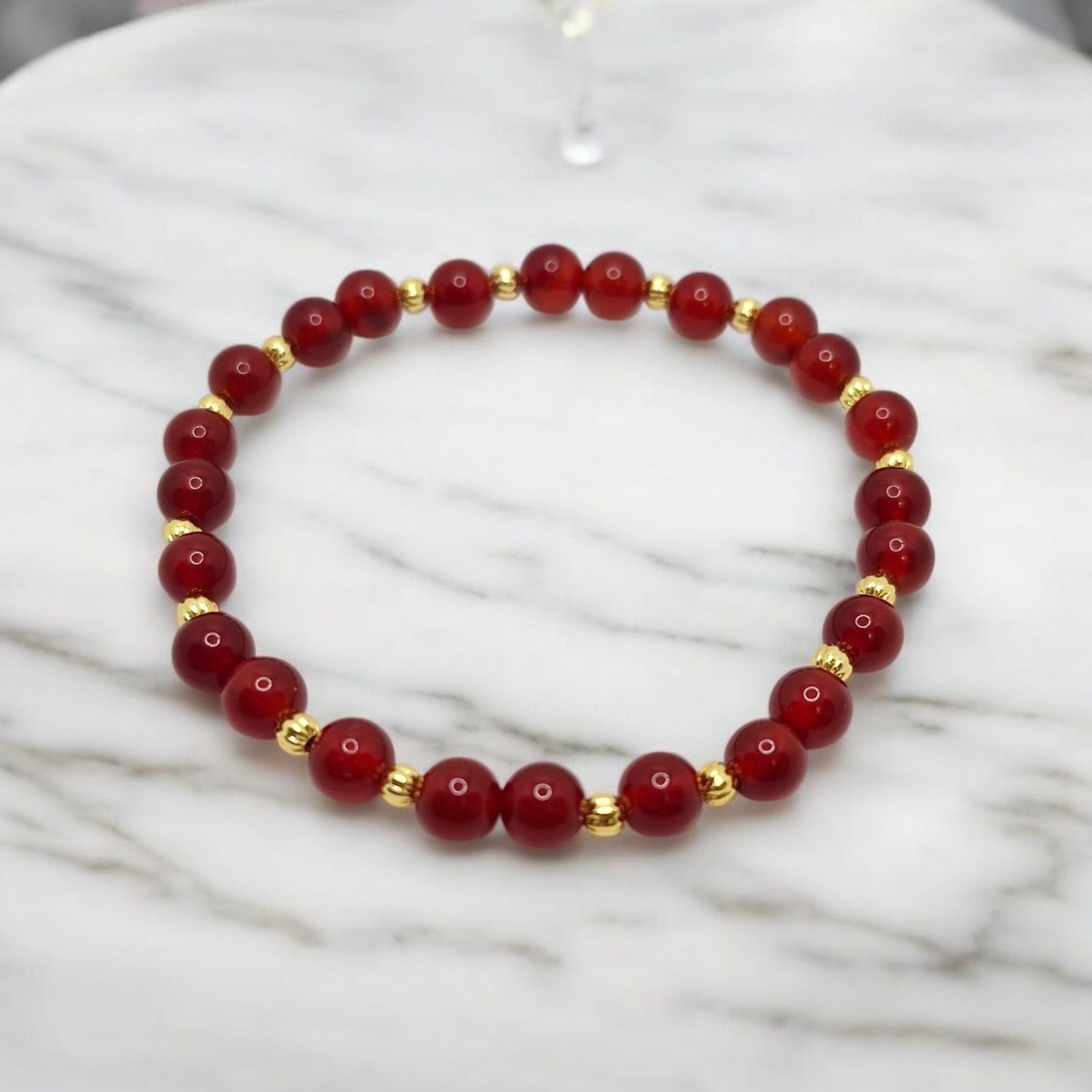 Stretch bracelet,red beads and gold plated corrugated beads