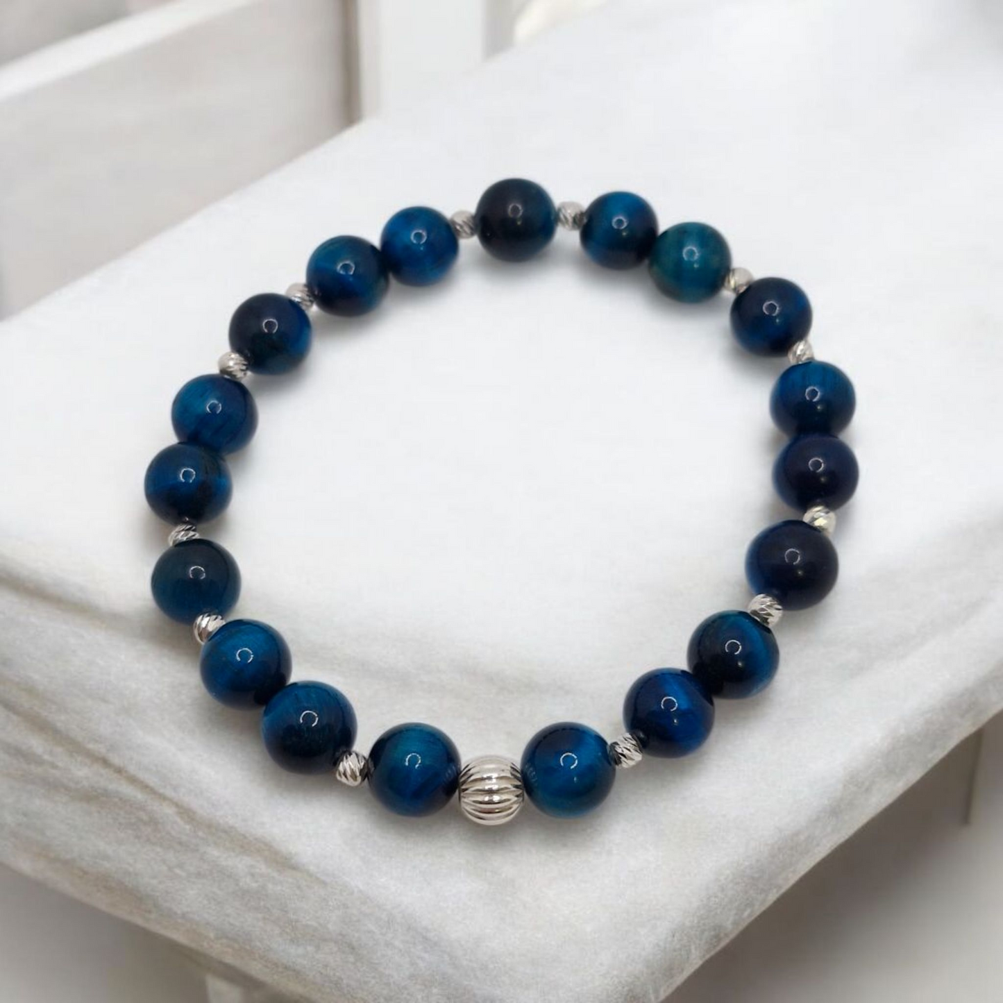 Blue beaded bracelet on a white surface