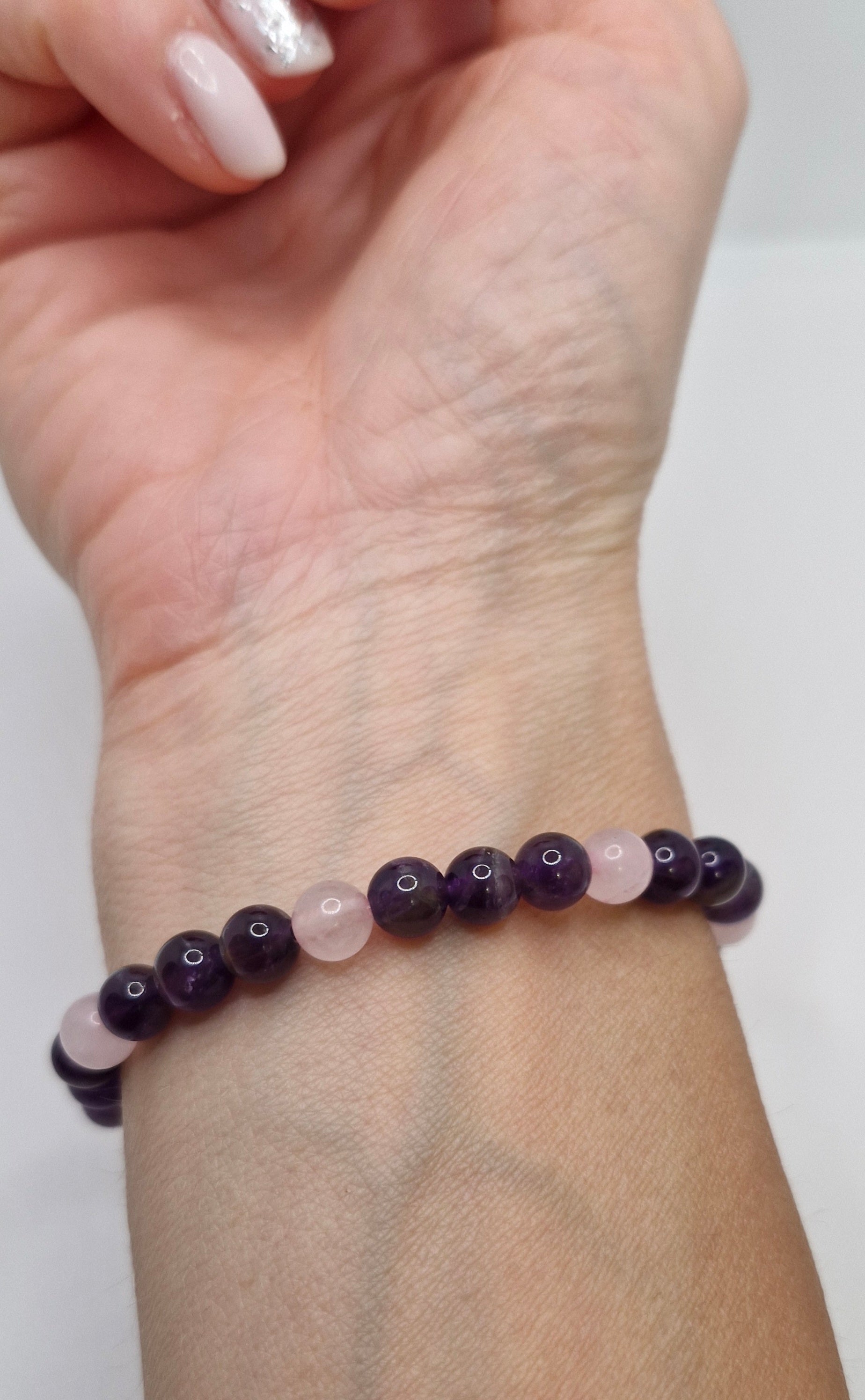 Beaded bracelet on a wrist with a white background
