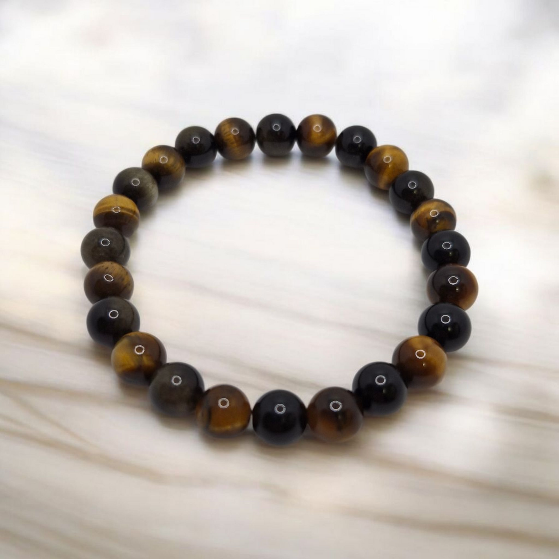 Beaded bracelet with black and brown beads on a white background