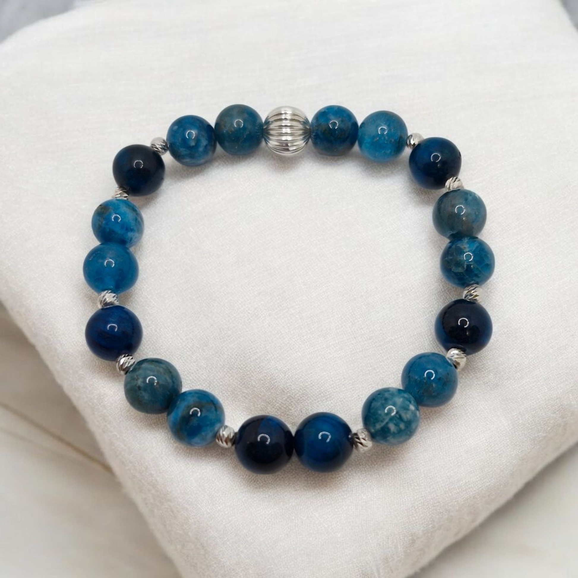 Blue beaded bracelet on a white cushion