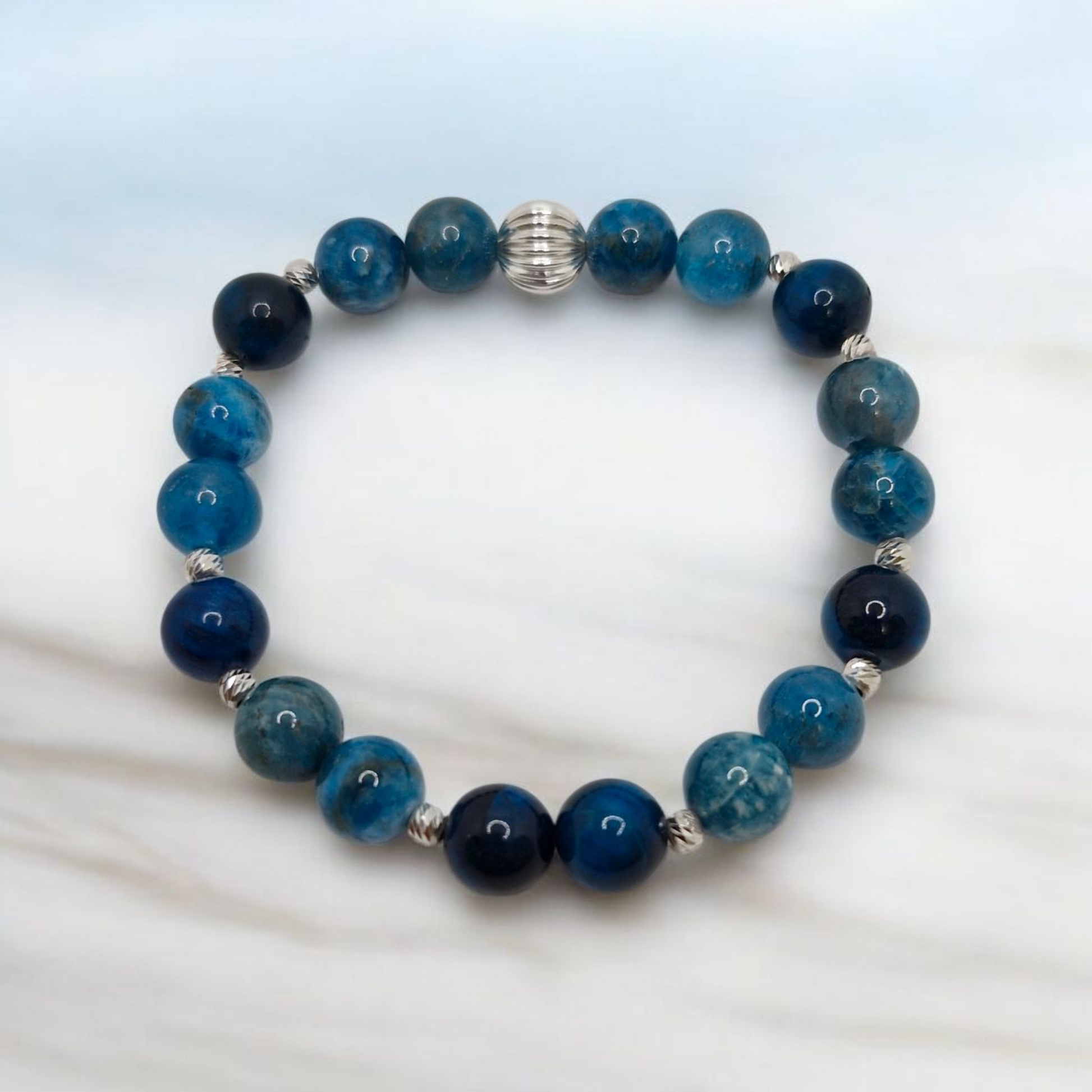 Beaded bracelet with blue and black beads on a white background