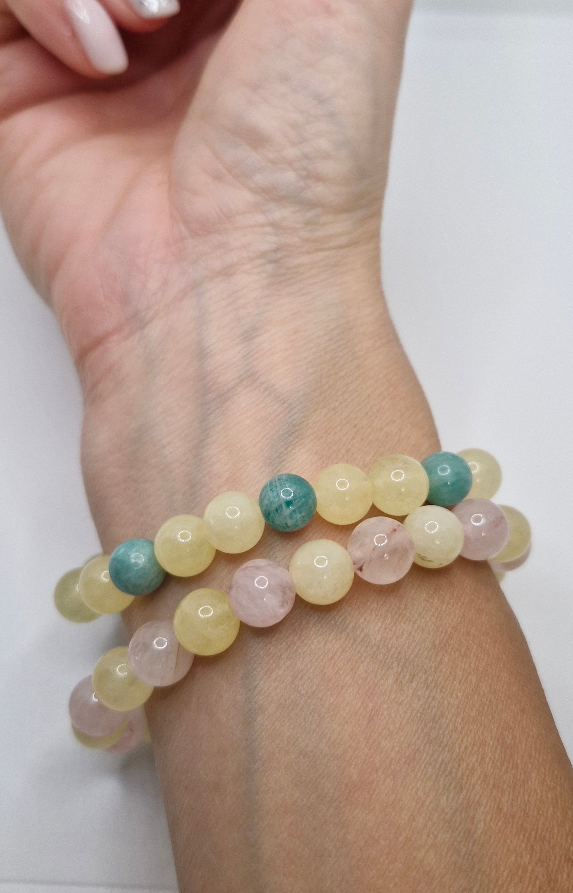 Multicolored beaded bracelet on a wrist with a white background