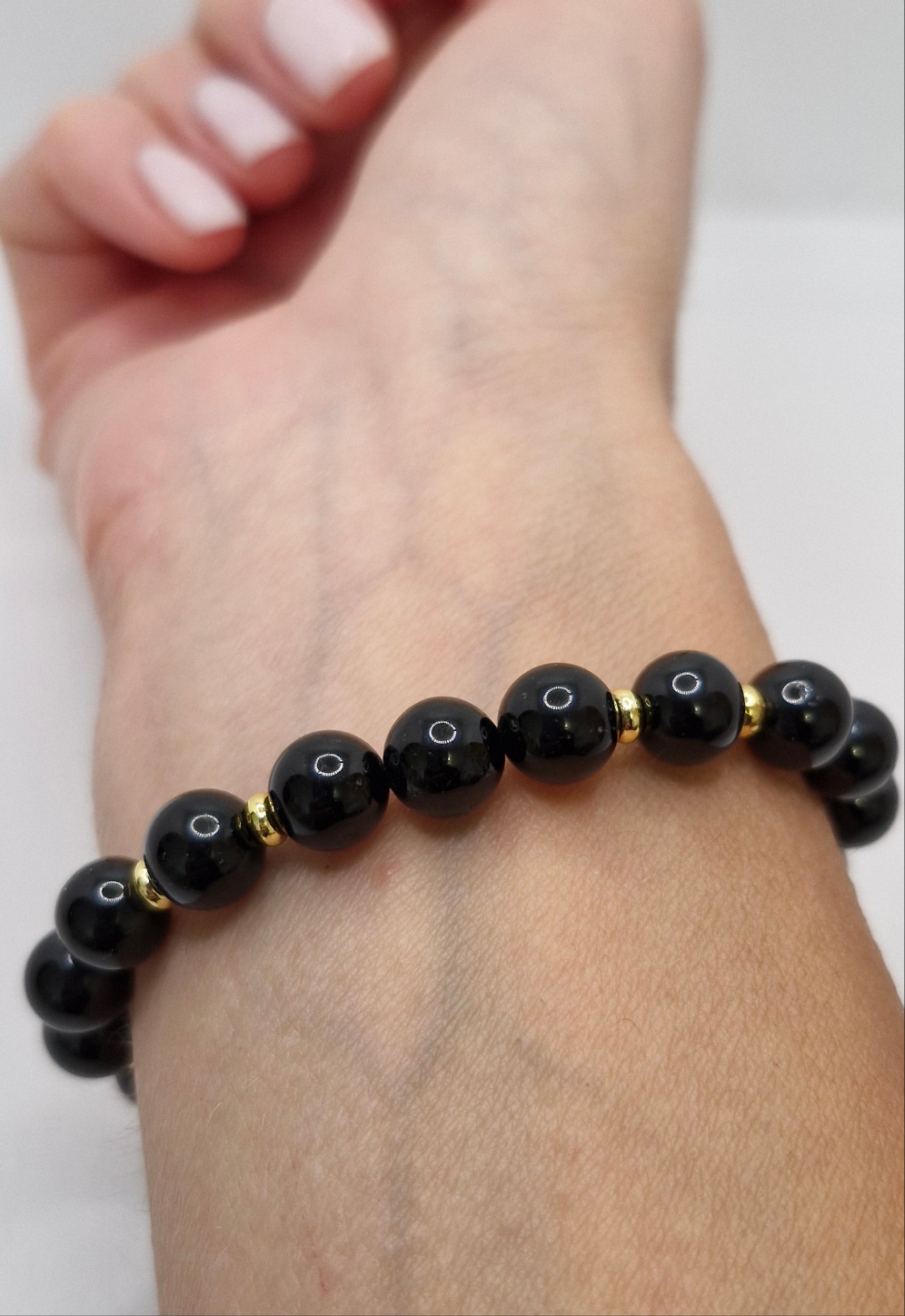Protective gemstone bracelet with 8mm Black Tourmaline and golden brass details, handcrafted design