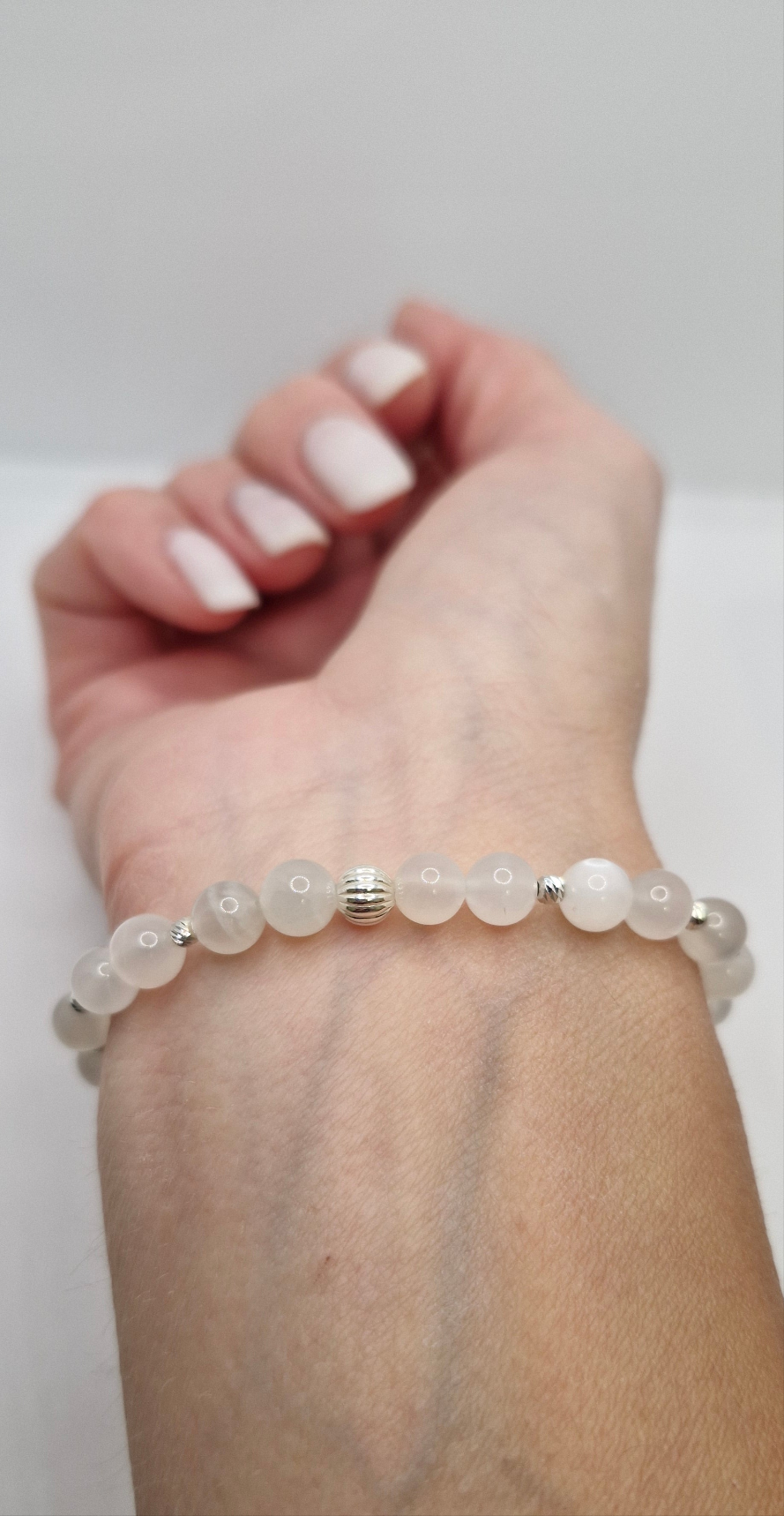 Close-up of glowing White Moonstone beads accented with 2.5mm and 5mm sterling silver beads