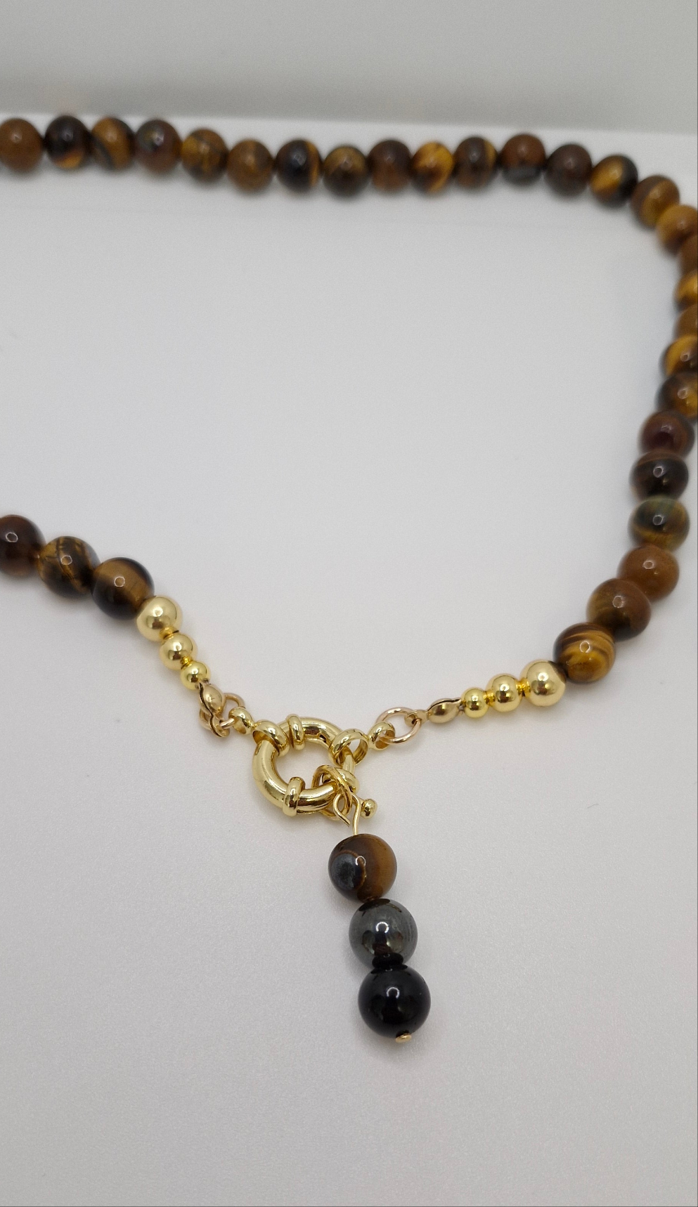 Unisex Tiger Eye protection necklace with versatile gold-plated clasp for front or back wear