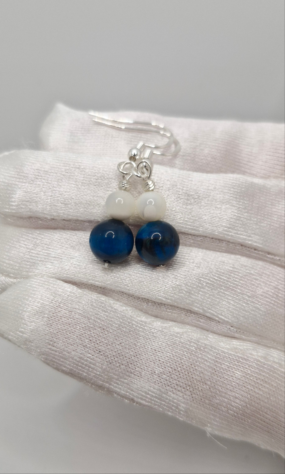 Luxury dangle earrings with calming Mother of Pearl and empowering Blue Tiger Eye gemstones