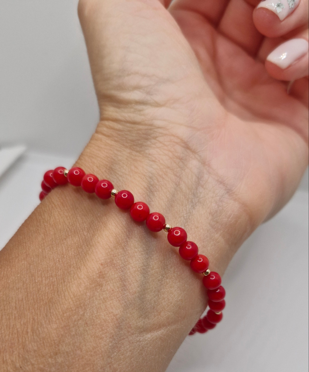 Elegant handmade Bamboo Coral stretch bracelet with rich red coral beads and polished gold filled accents, designed for everyday wear or special occasions.