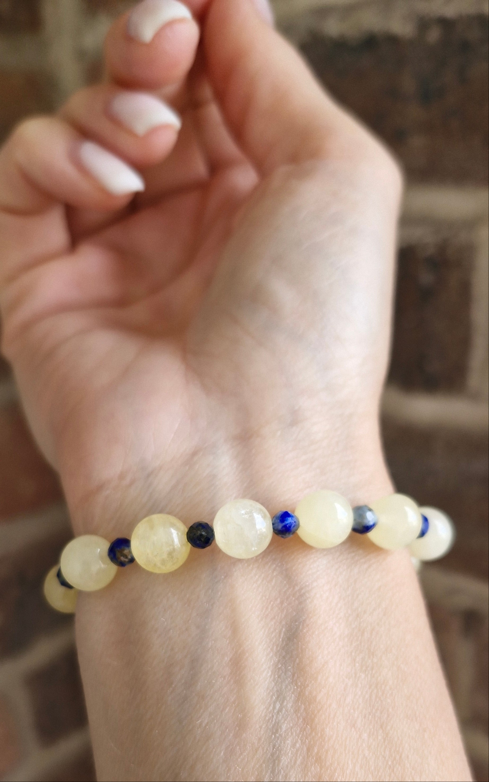 Golden Citrine stretch bracelet with blue Lapis Lazuli  accent beads worn on wrist for daily wear