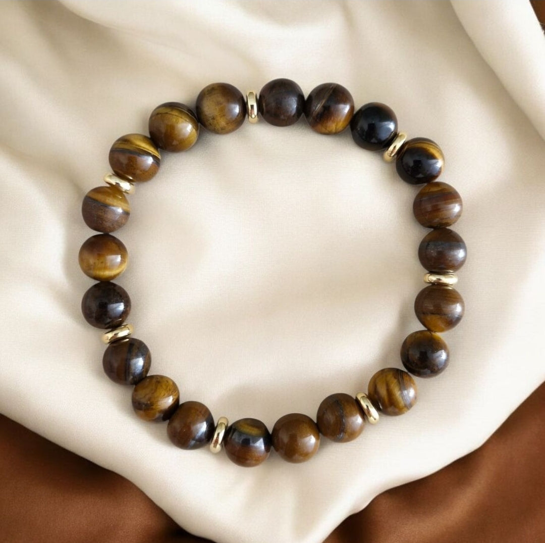 Close-up of Tiger Eye gemstone bracelet with golden-brown beads and polished gold plated brass accent