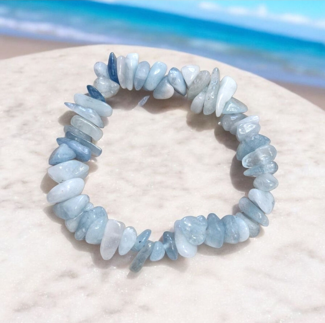 Aquamarine gemstone bead in chakra bracelet promoting clarity, peace, and emotional balance