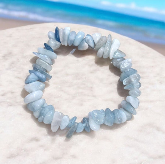 Aquamarine gemstone bead in chakra bracelet promoting clarity, peace, and emotional balance
