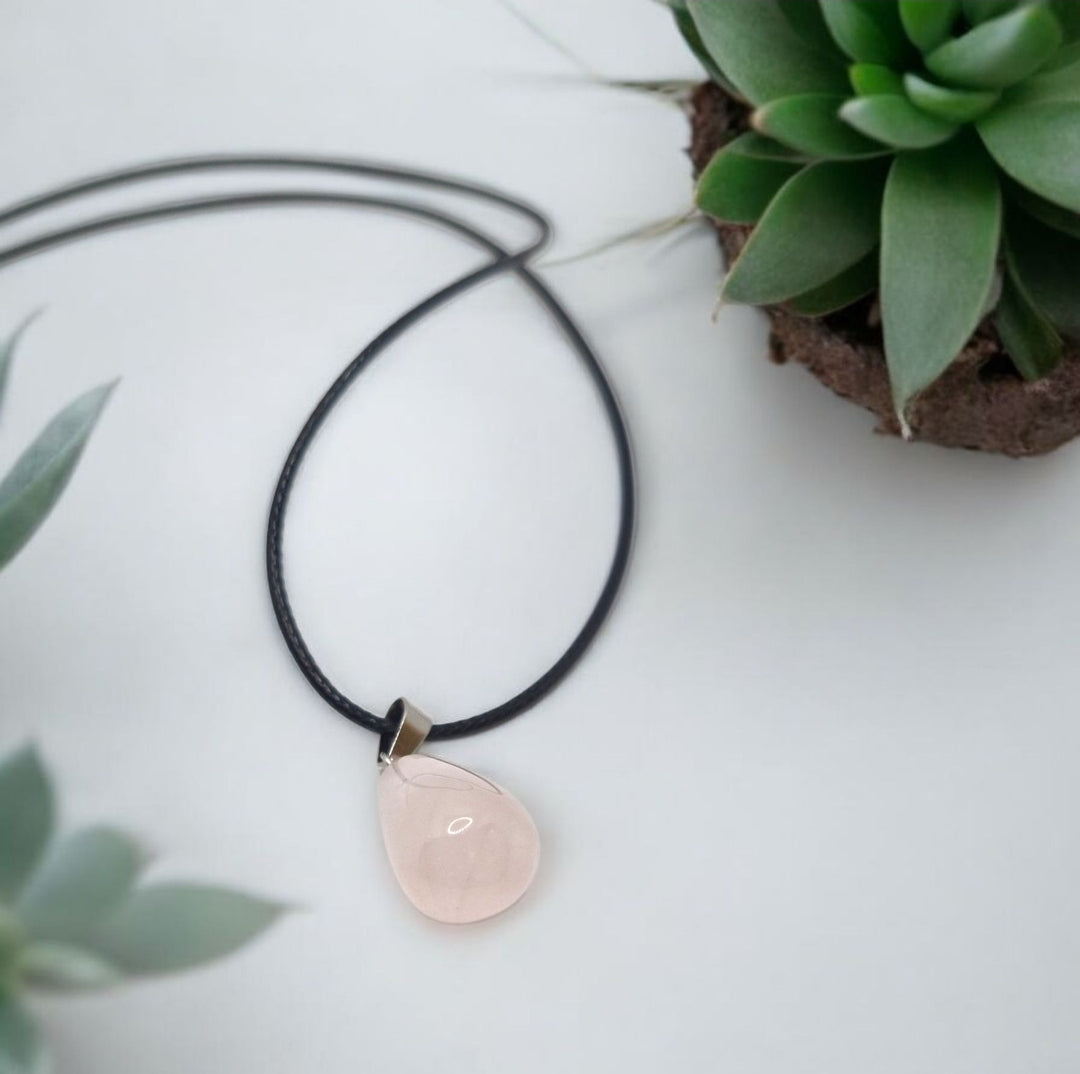 Natural rose quartz pendant necklace, teardrop shape gemstone symbolizing love and harmony, handmade crystal jewellery.