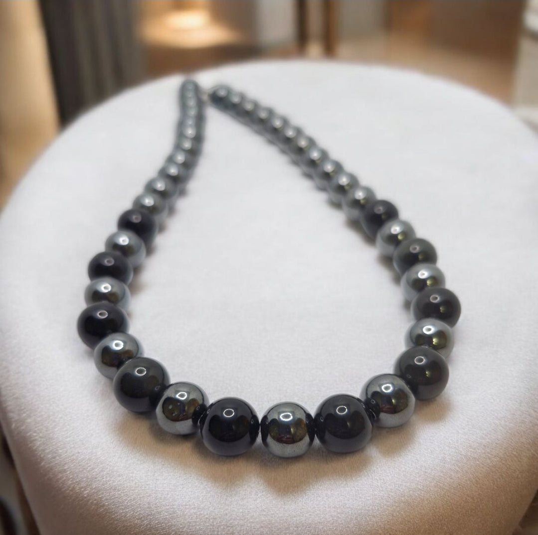 Close-up of stainless steel hook clasp on Obsidian and Hematite gemstone necklace