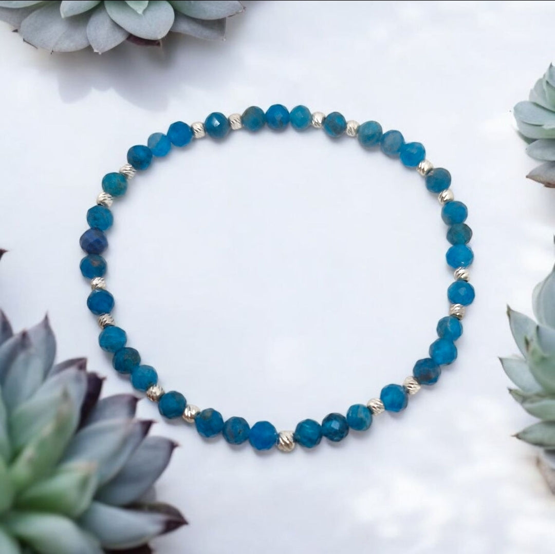 Close-up of faceted Blue Apatite beads and 2.5mm sterling silver corrugated beads on elastic bracelet