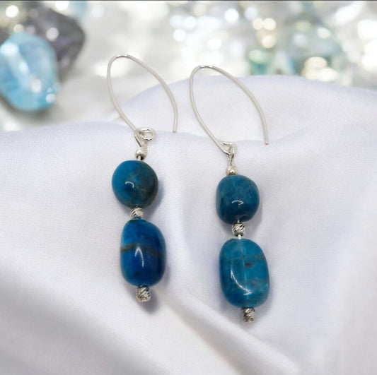 Close-up of natural oval Apatite gemstone earrings with sterling silver details