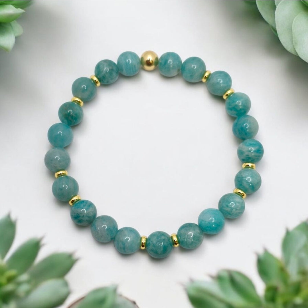 Close-up of aqua-green Amazonite beads accented with 4mm gold plated brass spacers on stretch bracelet