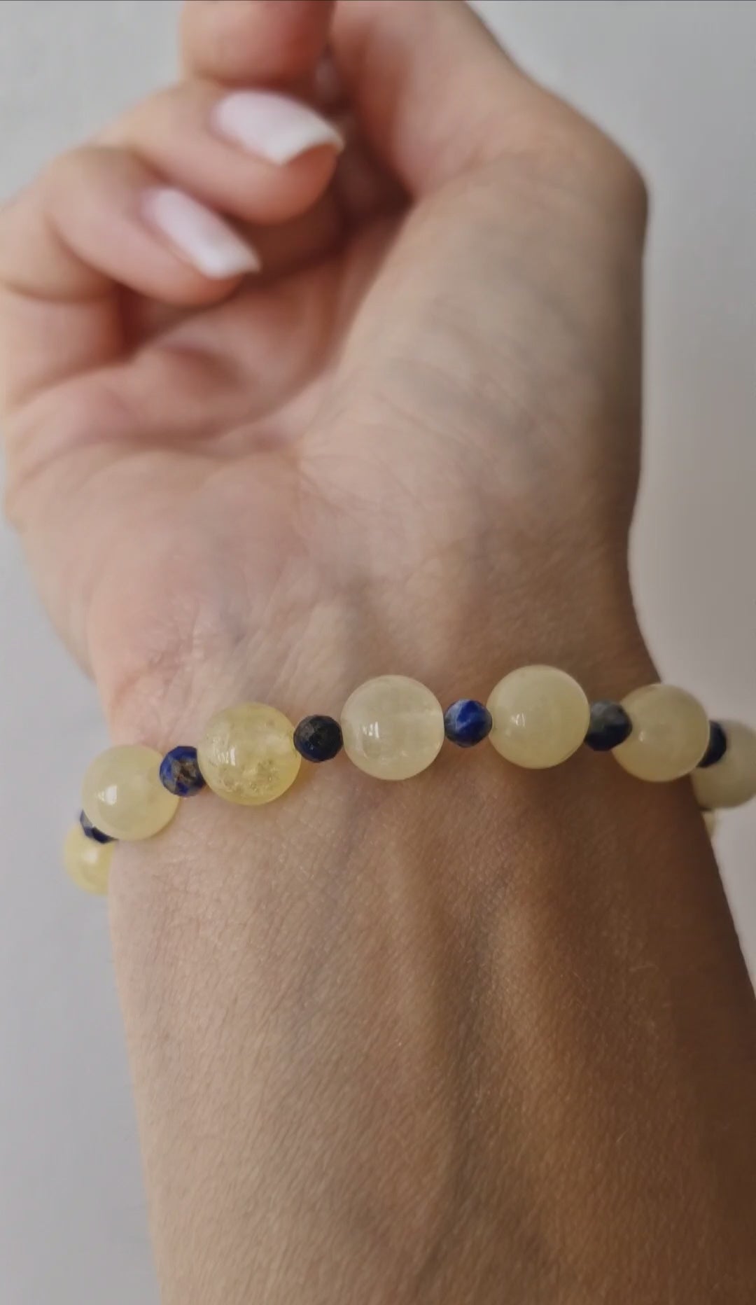 Video of handmade Golden Citrine stretch bracelet with 8mm stones, featuring 4mm Apatite or Lapis Lazuli accent beads for vibrant two-tone design.