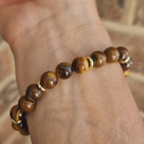 Video showcasing Tiger Eye gemstone bracelet with golden-brown crystal beads and polished brass accent