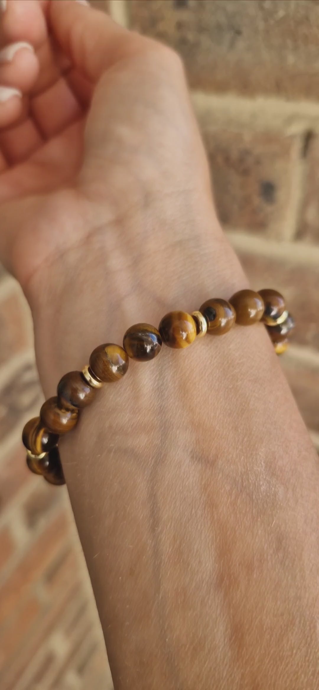 Video showcasing Tiger Eye gemstone bracelet with golden-brown crystal beads and polished brass accent