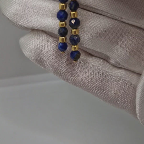Close-up video of handmade faceted 4mm Lapis Lazuli gemstone earrings with Toho seed beads on hypoallergenic gold-plated stainless steel hooks – lightweight, minimal, and sparkling jewellery design.