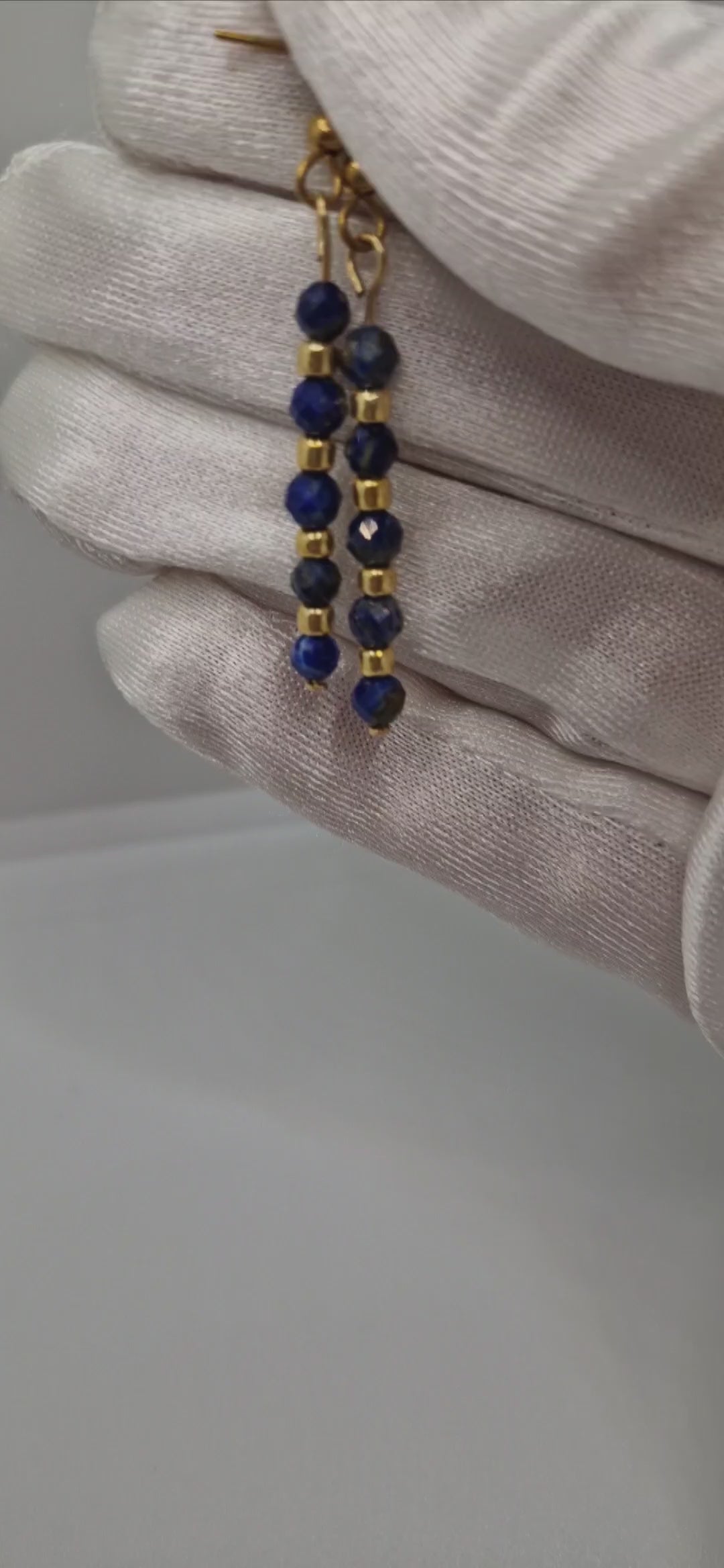 Close-up video of handmade faceted 4mm Lapis Lazuli gemstone earrings with Toho seed beads on hypoallergenic gold-plated stainless steel hooks – lightweight, minimal, and sparkling jewellery design.