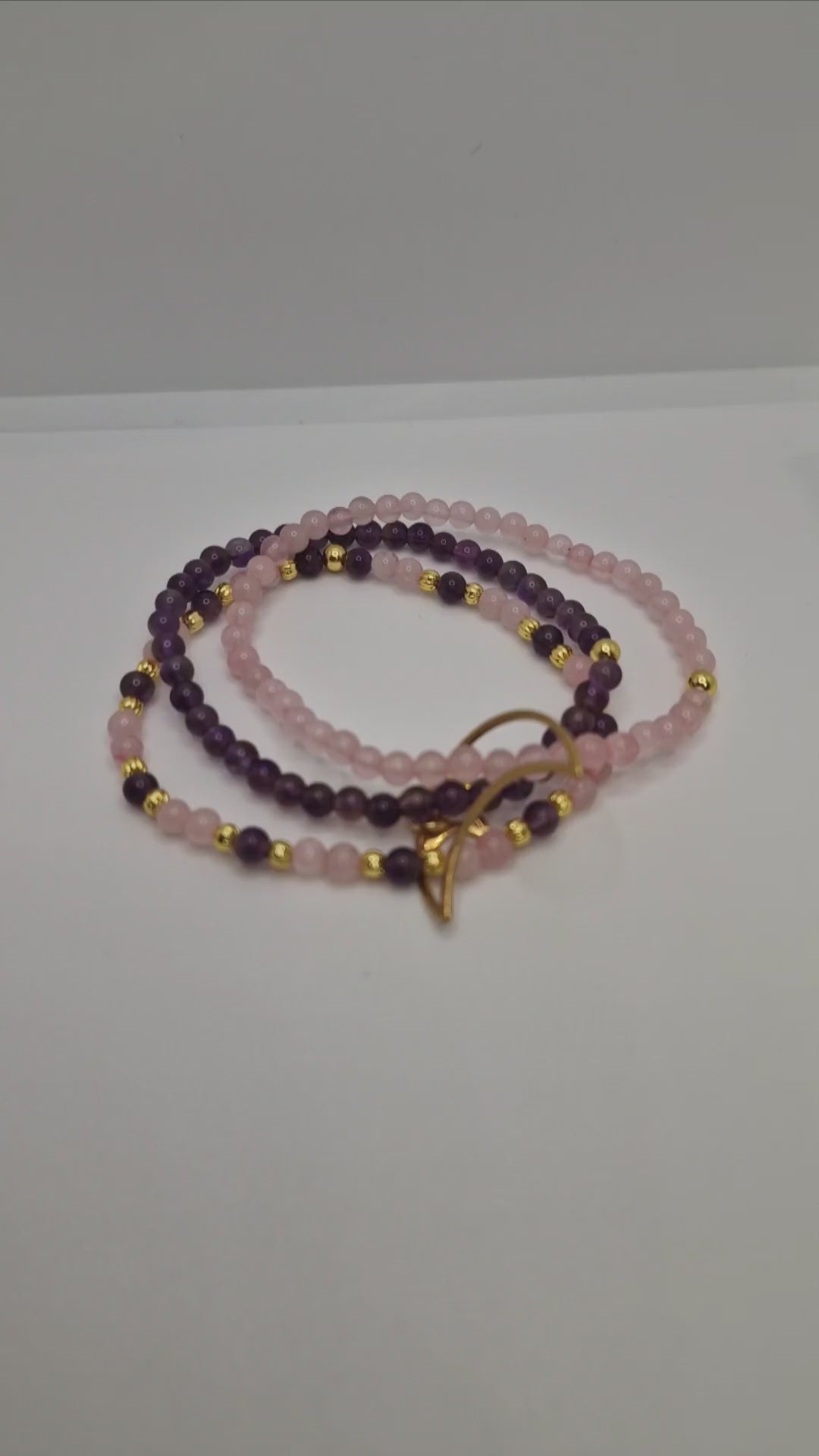 360° view of triple gemstone bracelet with Brazilian Amethyst and Rose Quartz, gold-plated corrugated beads, and Moon & Star charm highlighting sparkle and design
