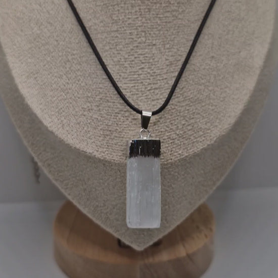 Video showing a handmade rectangular Selenite pendant on a black 1.5mm rope necklace, highlighting natural crystal texture and smooth finish.