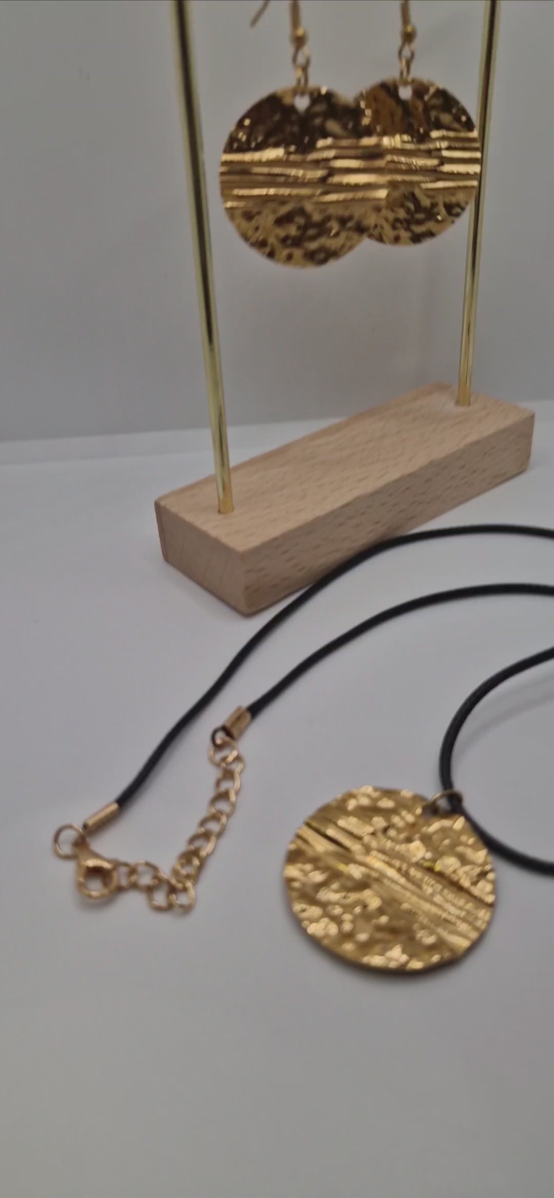 Demonstration of adjustable 1.5mm black waxed rope pendant necklace with matching earrings