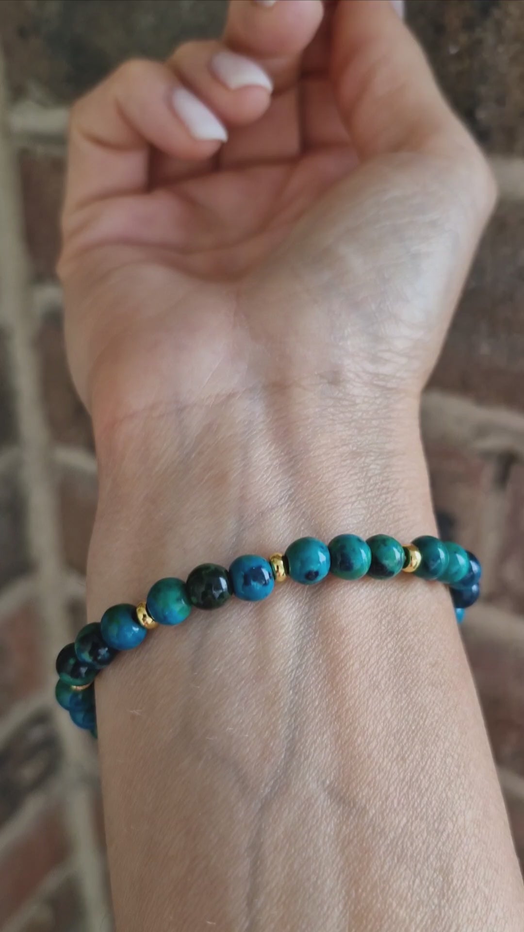 Demonstration of Chrysocolla bracelet worn on wrist, highlighting gold-plated accents